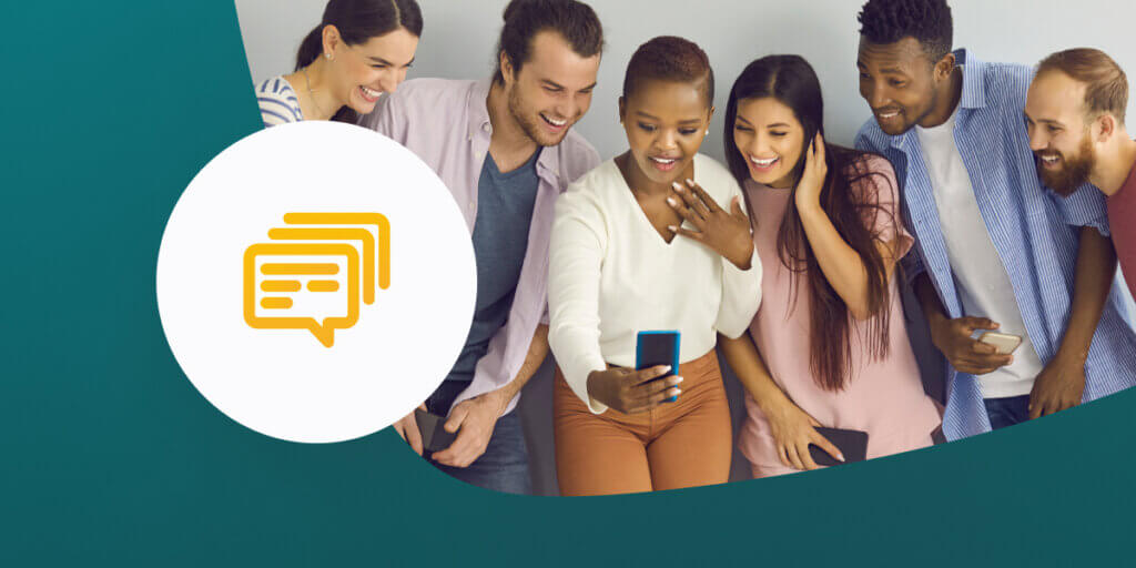 Group of people gathering around to look at text on mobile phone.