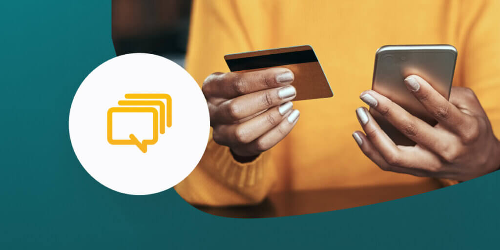 Person using credit card and mobile phone to buy online.