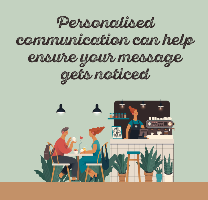 Couple sat in a restaurant, with a employee behind them making coffee